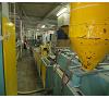 Line of extrusion of profiles P.V.C. Extruder AMUT. Foto