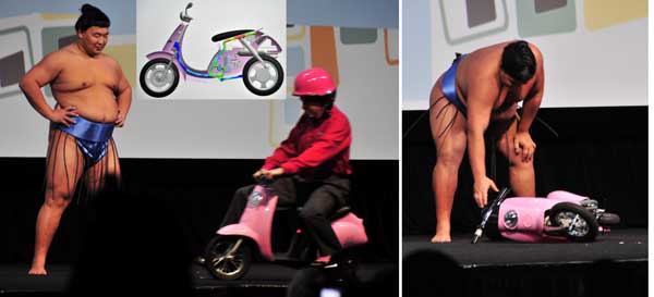 On the left, Jeff Ray, CEO of SolidWorks, leads a miniscooter pink, with pink helmet...