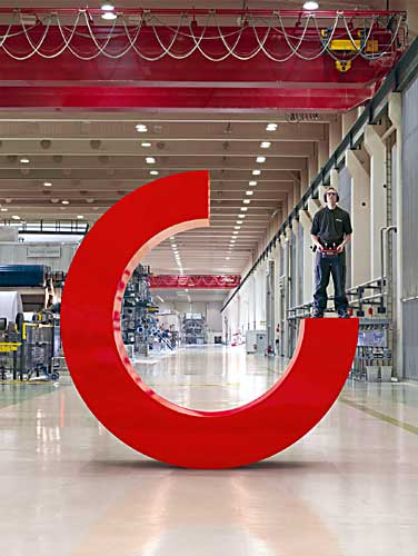 An operator uses one of the supplies to move a C, part of the logo of the company, in giant version