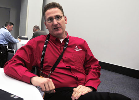 Austin J. O'Malley, wearing a red shirt to indicate that it is part of the r & d Department