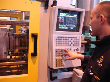 In the photo, Aimplas technician performs a test of molding by injection