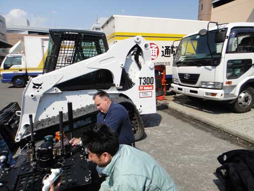 Workers developing a compact loader of caterpillars Bobcat T300