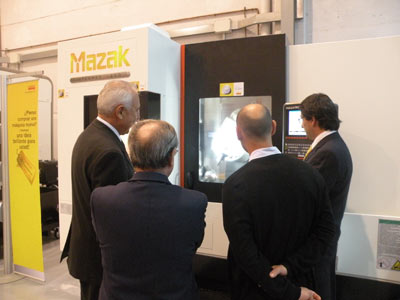 Several customers observe the demonstration of the Integrex j200