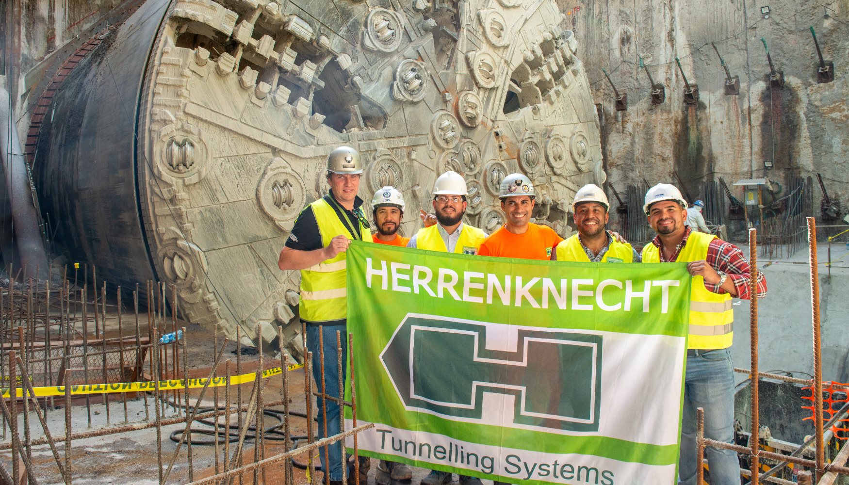 Los miembros del equipo de Herrenknecht ondean con orgullo la bandera de la empresa tras un exitoso avance intermedio hacia la futura estaci�n de...