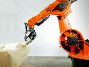 Un robot Kuka operando sobre un modelo de salpicadero